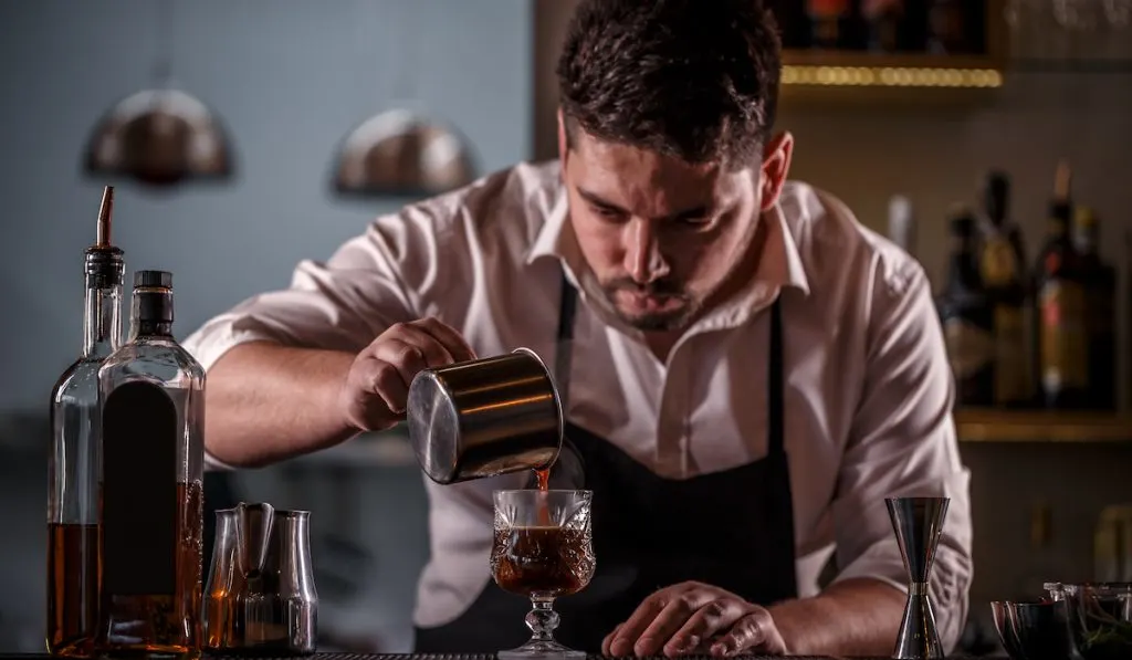 barista pouring coffee carefully