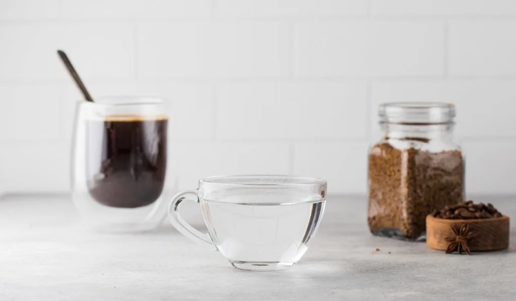 cold water in a clear cup and coffee