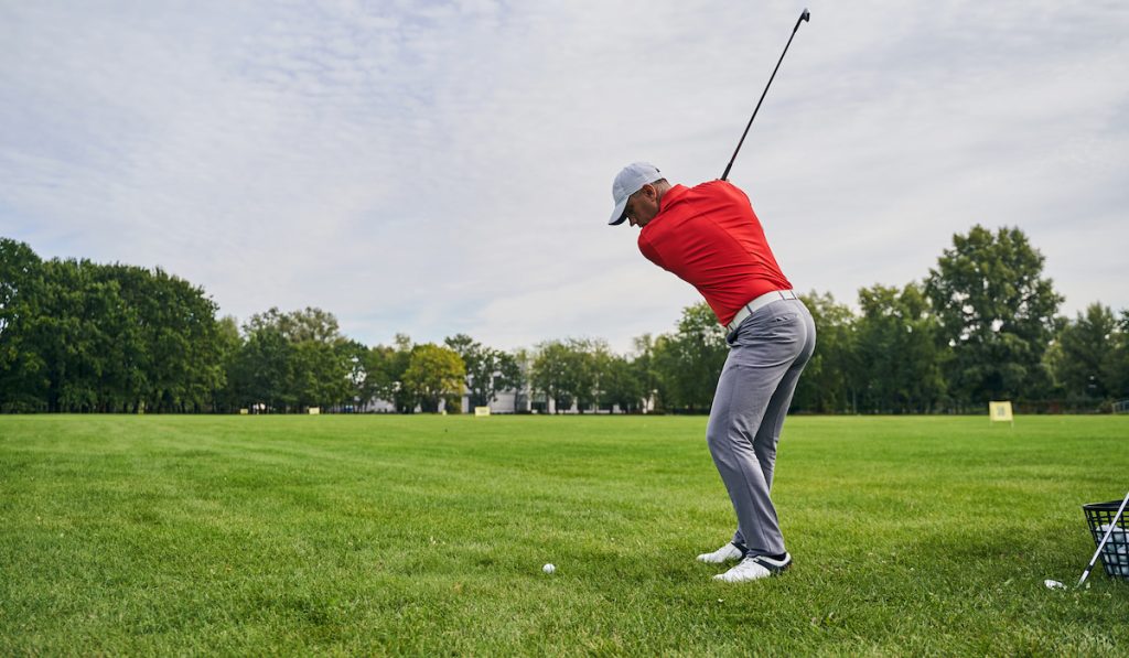 golf player practicing stroke