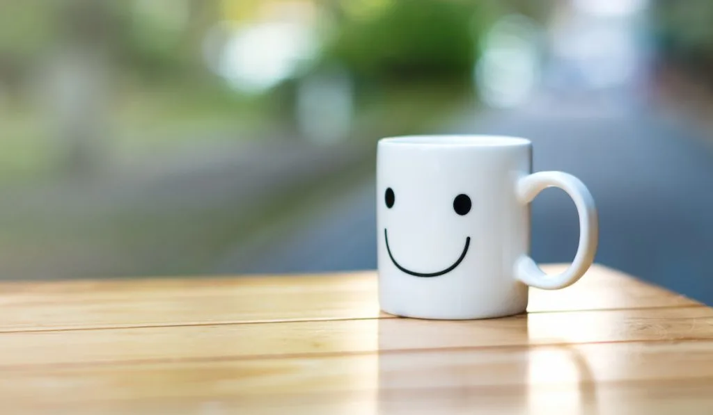 white coffee cup with a happy face design