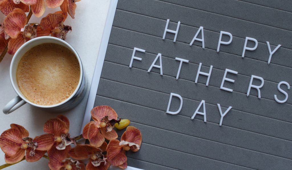 coffee cup and a happy father's day sign