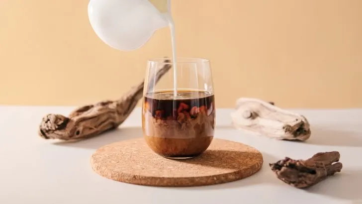pouring cream on coffee