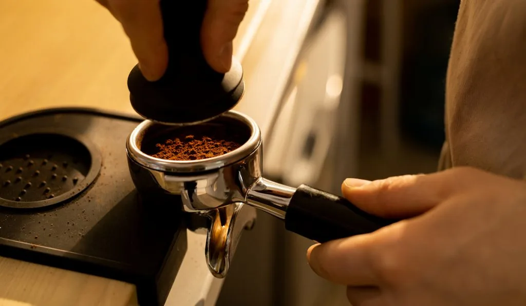 pressing ground coffee